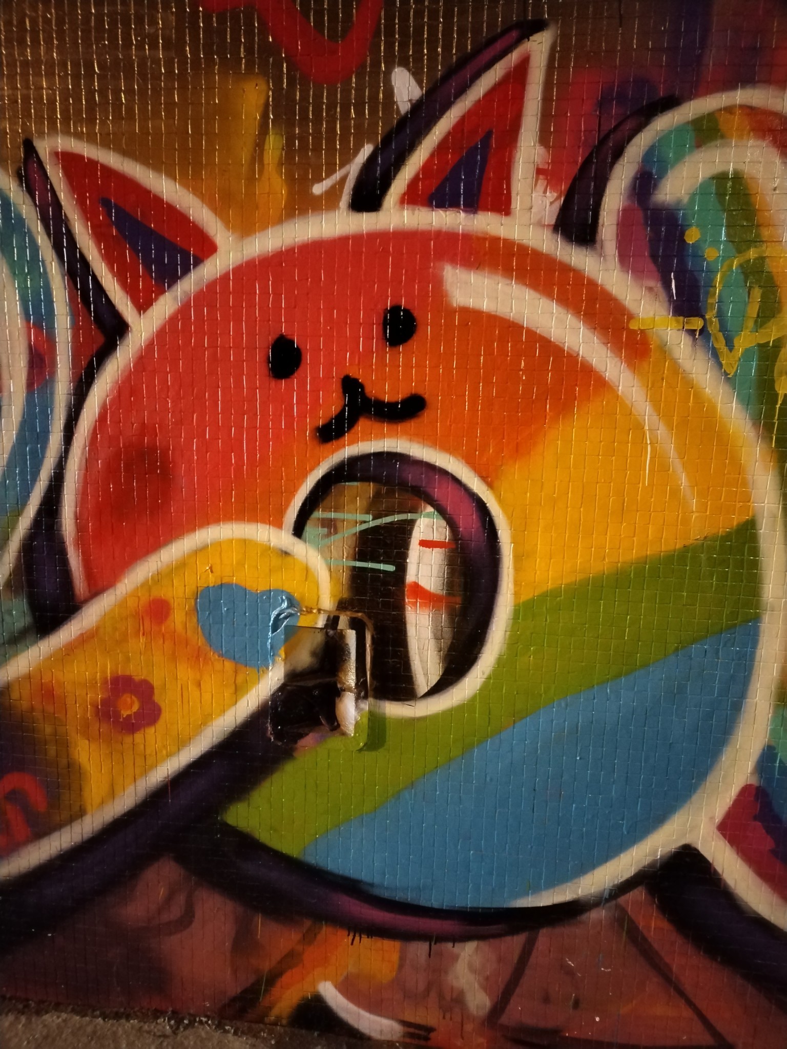 Graffiti of a cartoon rainbow donut cat