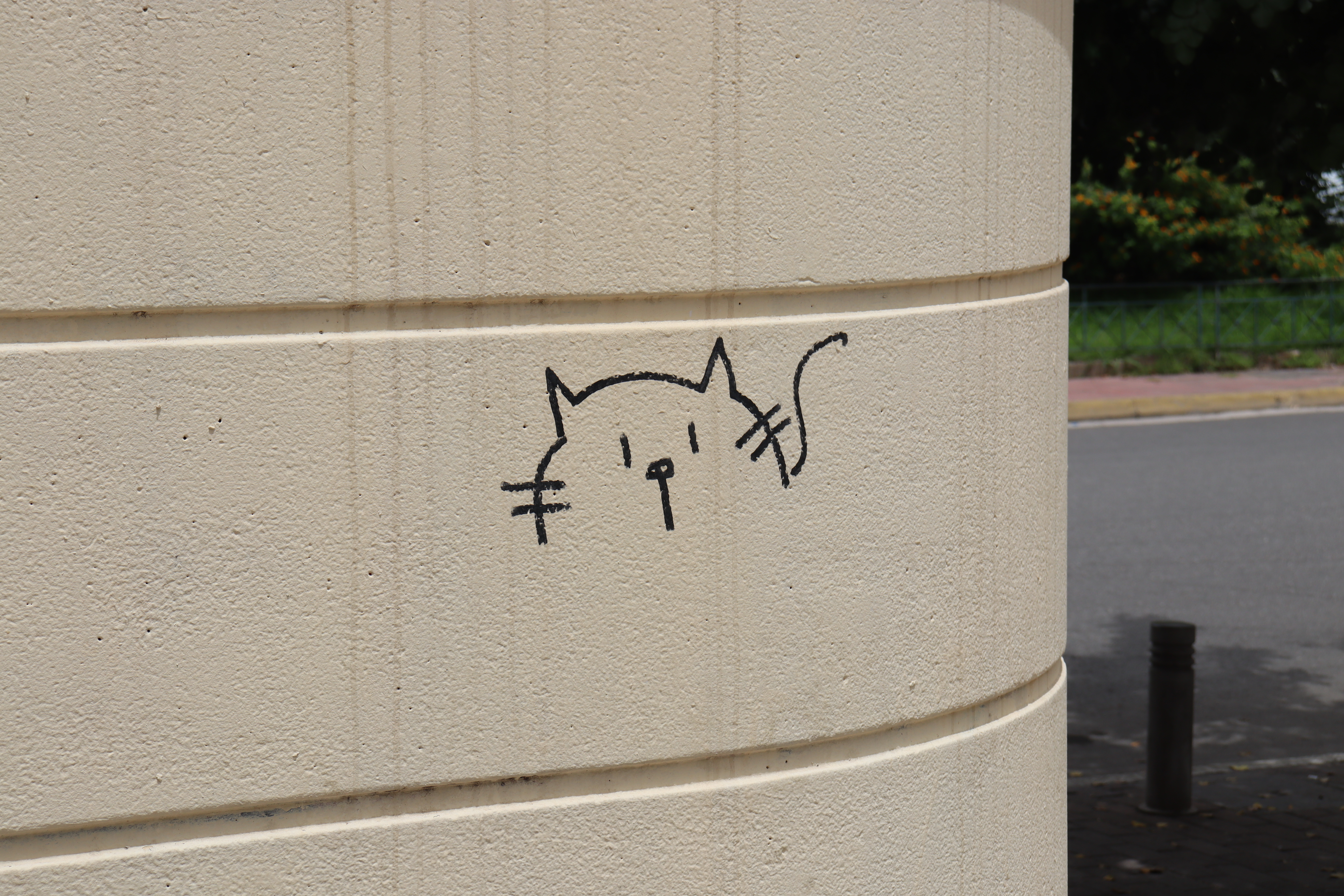 small cat drawn on a wall