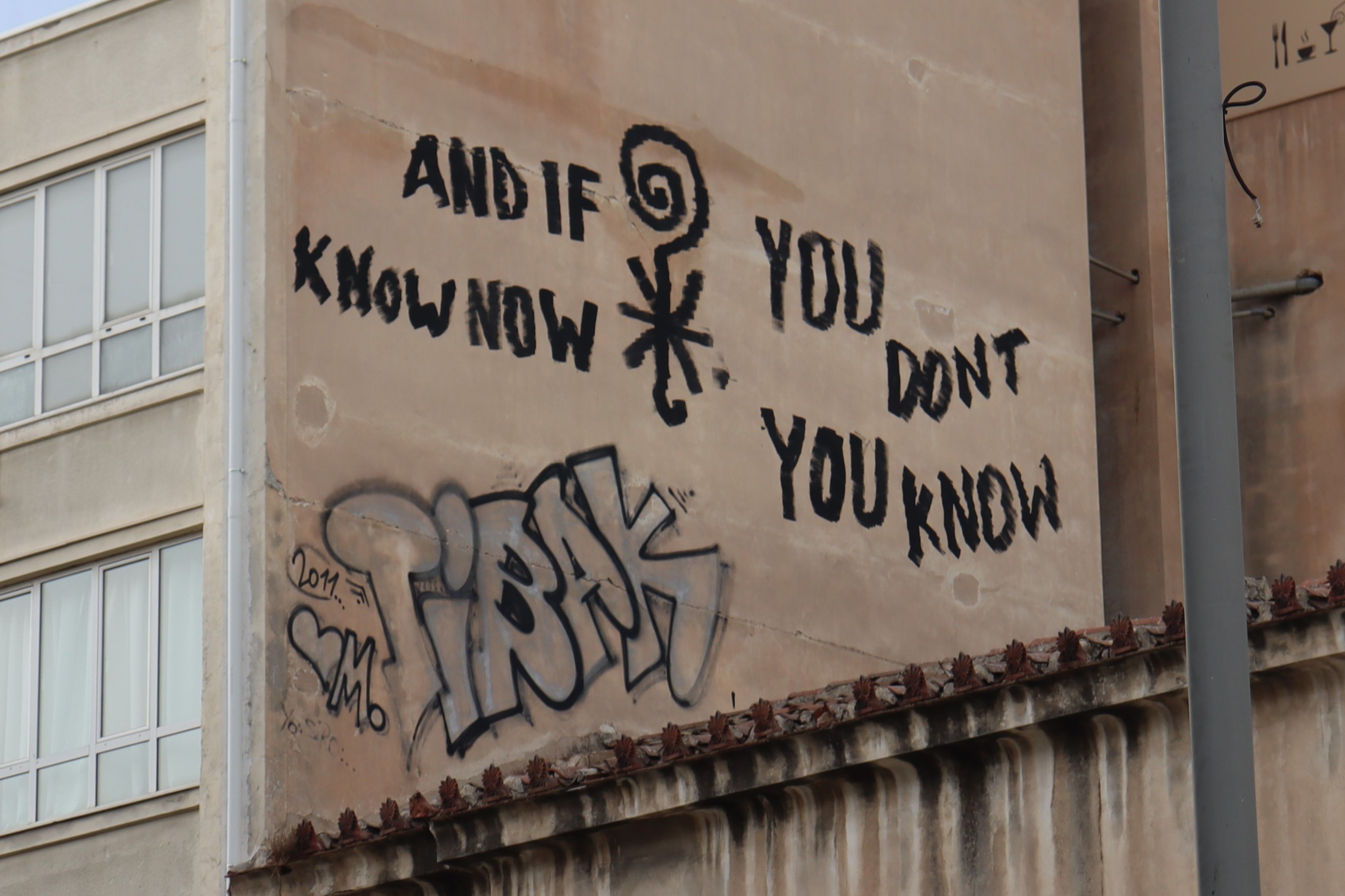 Graffiti that reads 'and if you don't know now, you know'. It's difficult to tell the exact order the words are meant to be read in